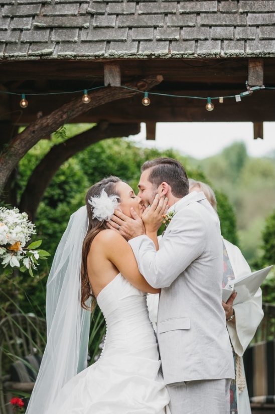 Bride and groom sharing a tender wedding kiss