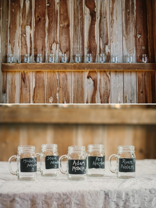 Mason jars with chalkboard name tags on rustic wood