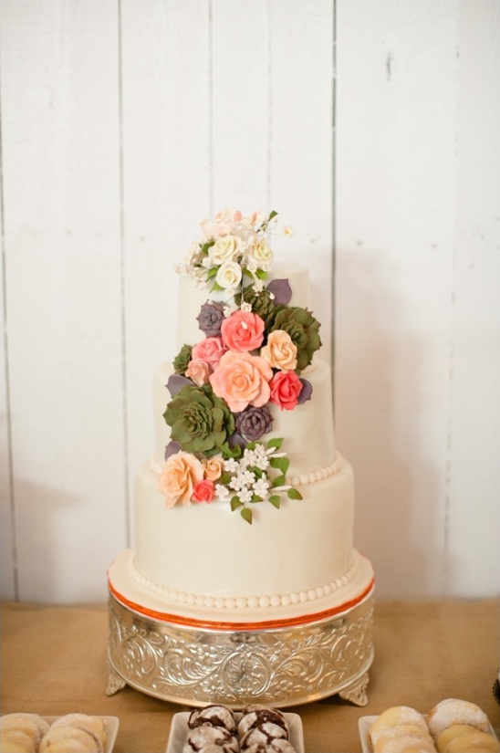 Elegant three-tiered wedding cake with floral decor