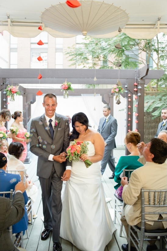 Happy couple walking down the aisle at their wedding
