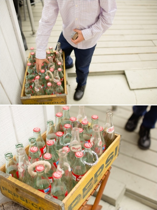 Boy playing ring toss with vintage Pepsi Cola bottles