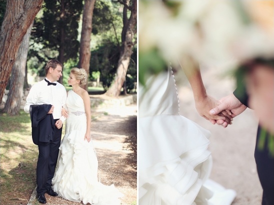 Romantic wedding couple walking in a park holding hands together
