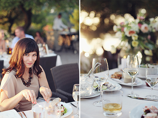 Woman smiling at outdoor dinner, wine glasses and floral decor