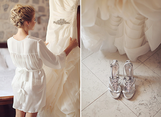 Bride admiring her wedding dress and bridal shoes on the floor