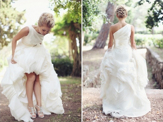 Bride in elegant wedding dress, looking at her shoes outdoors
