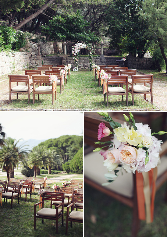 Outdoor wedding ceremony setup with floral arch and chairs
