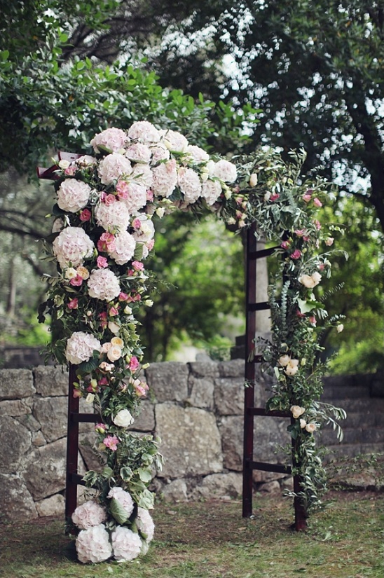 Floral wedding arch decorated with lush, romantic flowers