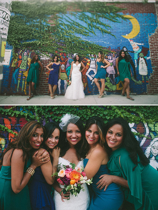 Bride and bridesmaids posing in front of colorful mural