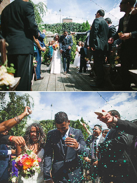 Newlyweds walk through confetti after their wedding ceremony