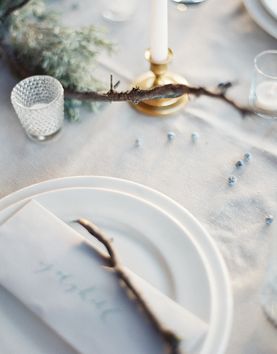 Elegant table setting with candle, plate, and napkin detail