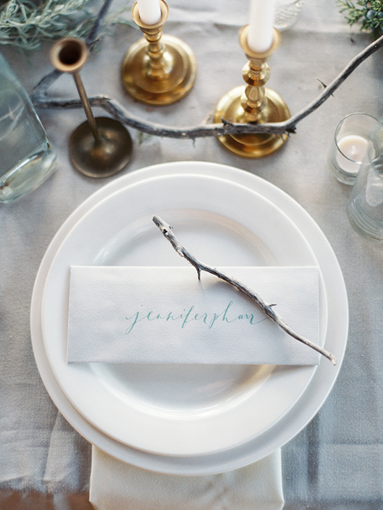 Elegant place setting with candles and rustic decor details