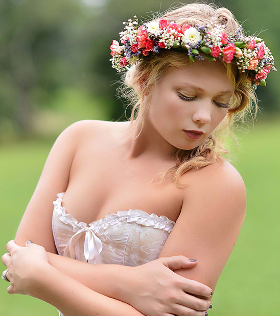 Woman in white corset wearing floral crown