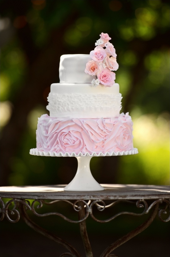 Elegant three tier wedding cake with pink roses