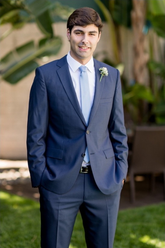 Groom in a navy blue suit, light blue tie