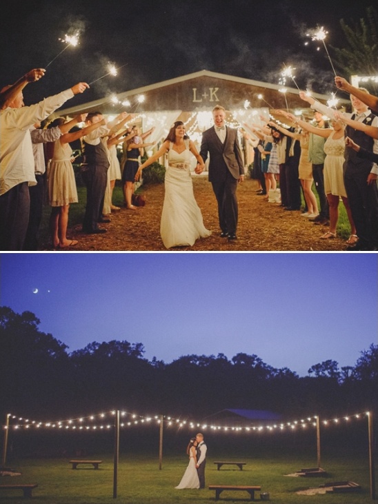 Couple exits wedding with sparklers and string lights