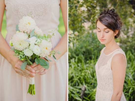 Bride in lace dress holding white wedding bouquet