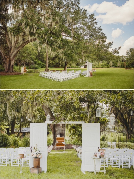 Outdoor wedding setup with white chairs and rustic decor