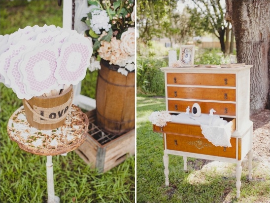 Rustic wedding decor love fans and vintage dresser