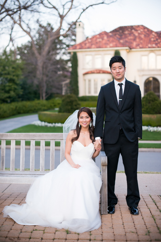Asian couple posing on their wedding day, holding hands
