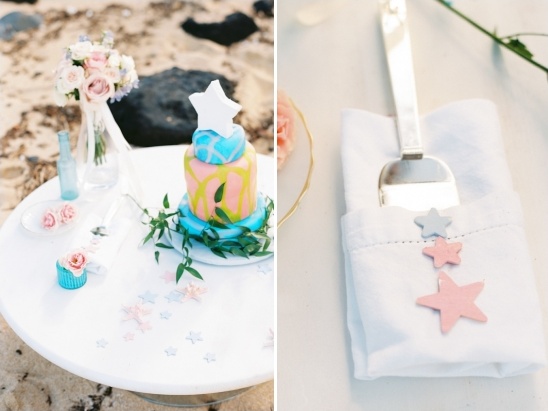 Whimsical pastel wedding cake and stars on a white table