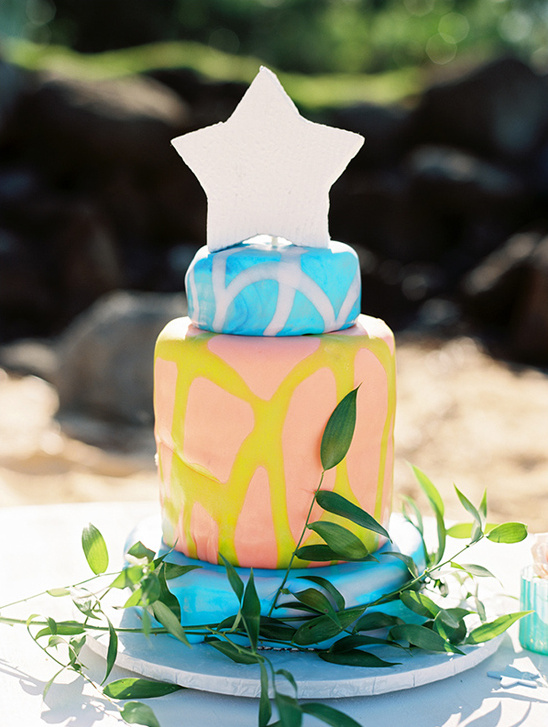 Colorful beach themed cake with star, topped with a star
