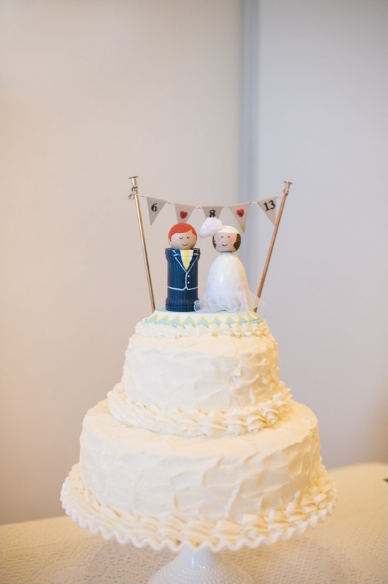 Wedding cake with unique wooden doll cake topper