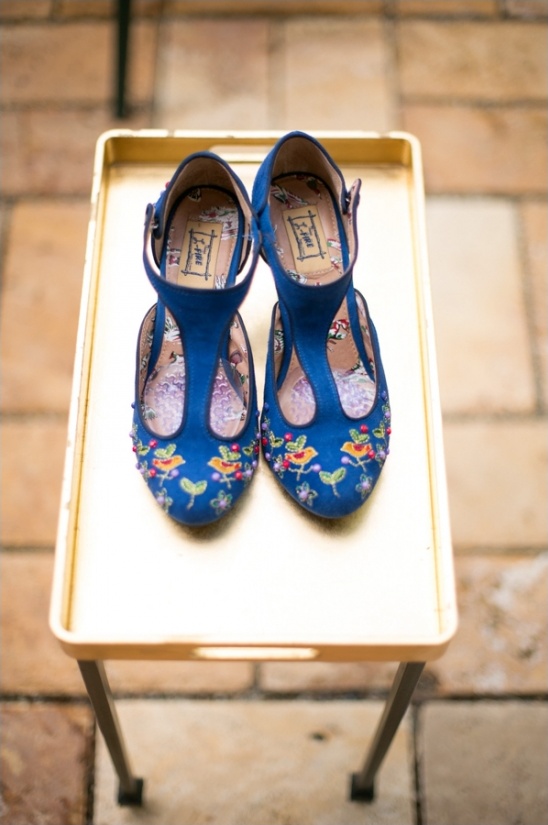 Blue embroidered shoes on a golden tray, perfect for a special occasion