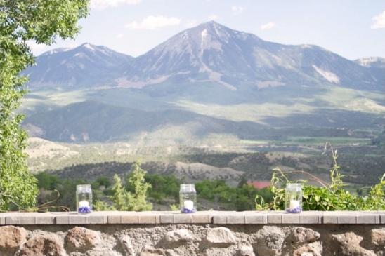 Stunning mountain view with candles in mason jars in foreground