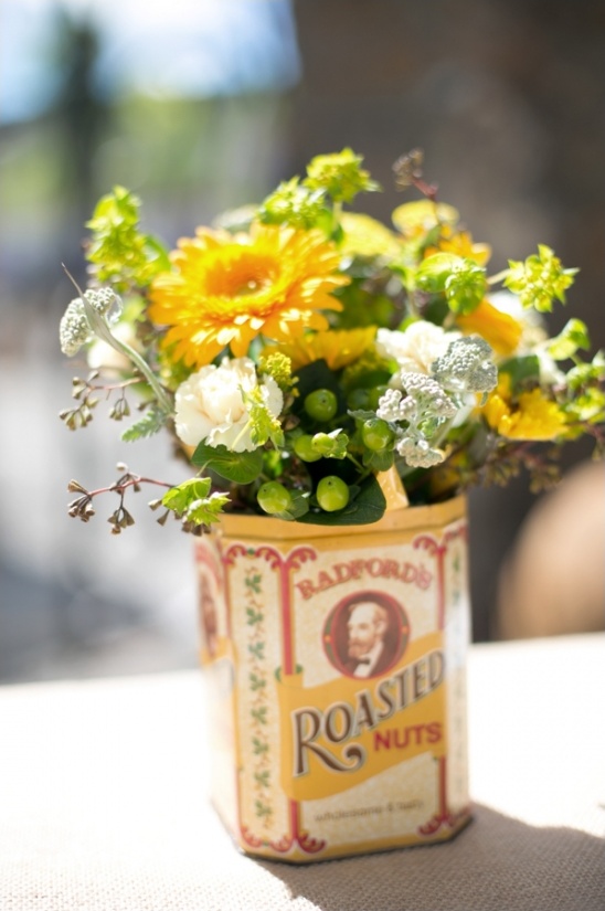 Fresh yellow flowers in vintage Roasted Nuts tin vase