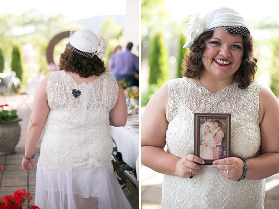 Bride in vintage wedding dress holding wedding photo with a smile