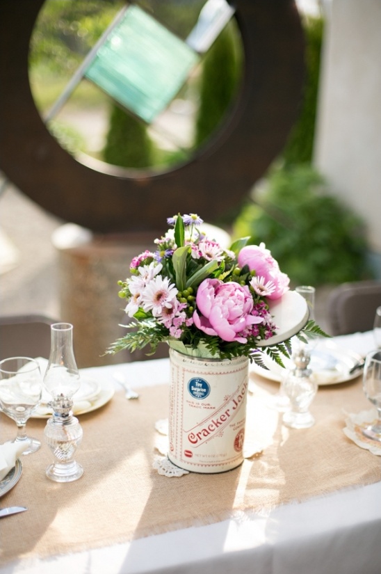 Flowers in a Cracker Jack can used as a rustic table centerpiece