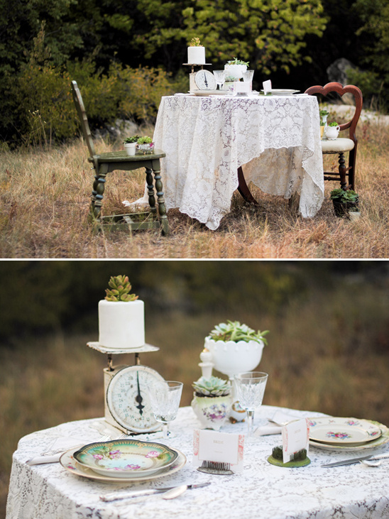 Elegant outdoor wedding table with floral plates and succulents