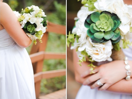 Bride holding a beautiful white and green wedding bouquet