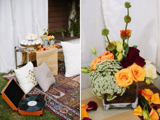 Bohemian picnic scene with flowers, pillows, and a record player