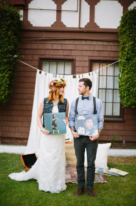 Bride and groom holding album covers at a wedding ceremony
