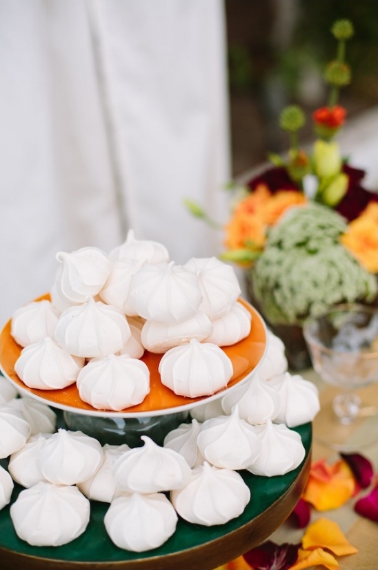 White meringues artfully displayed on a vibrant cake stand