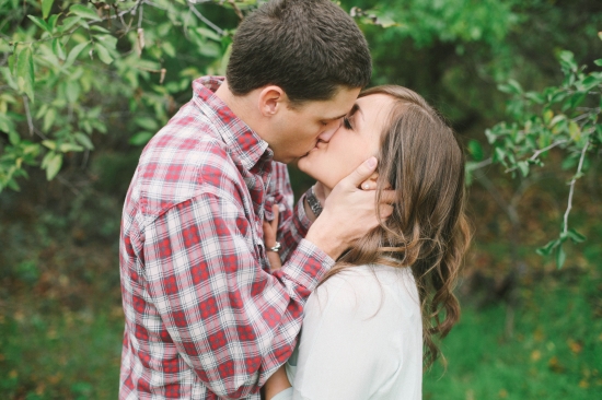 Romantic couple sharing a tender kiss outdoors, a moment of love
