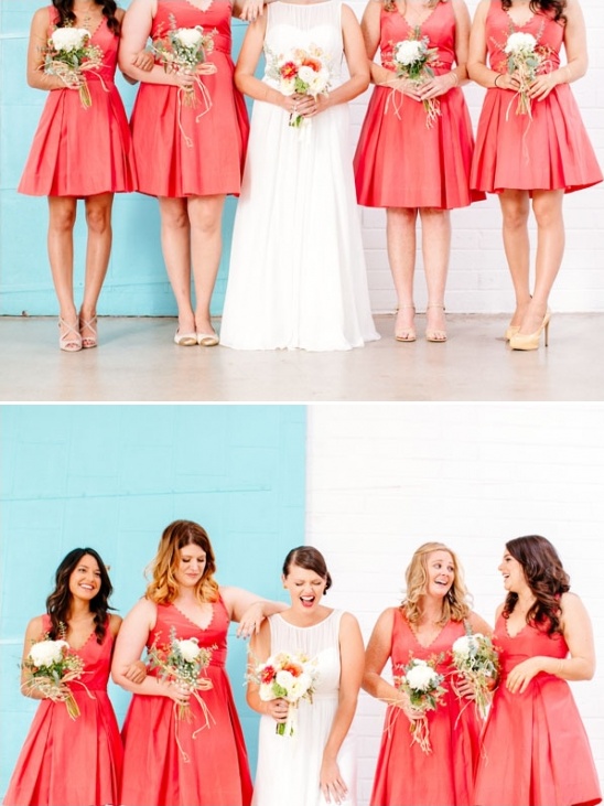 Bridesmaids in coral dresses with bride, holding bouquets, smiling and happy