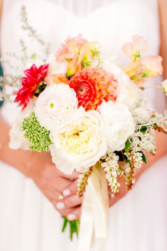Bride holding a beautiful colorful bridal flower bouquet