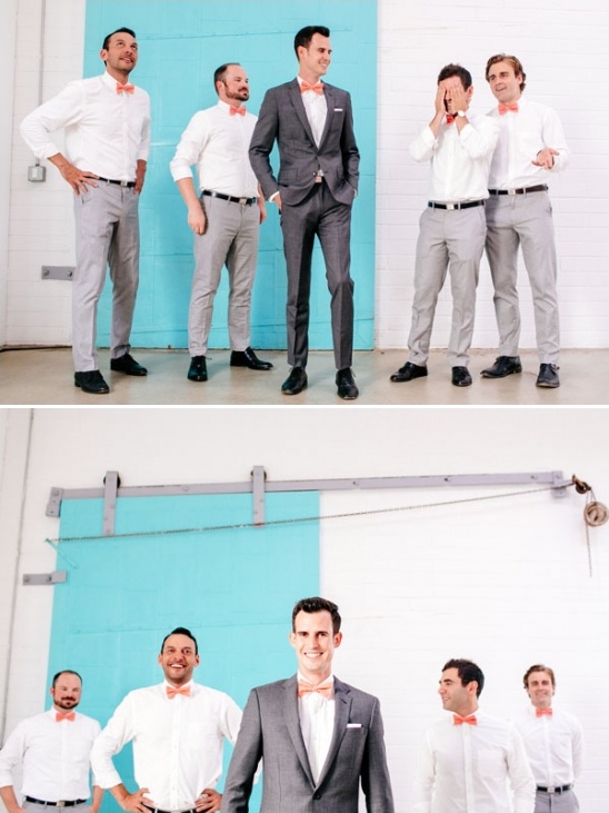 Group of groomsmen posing in suits and bowties