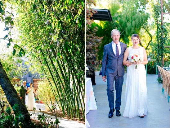 Bride and her father walk down the aisle in a garden setting