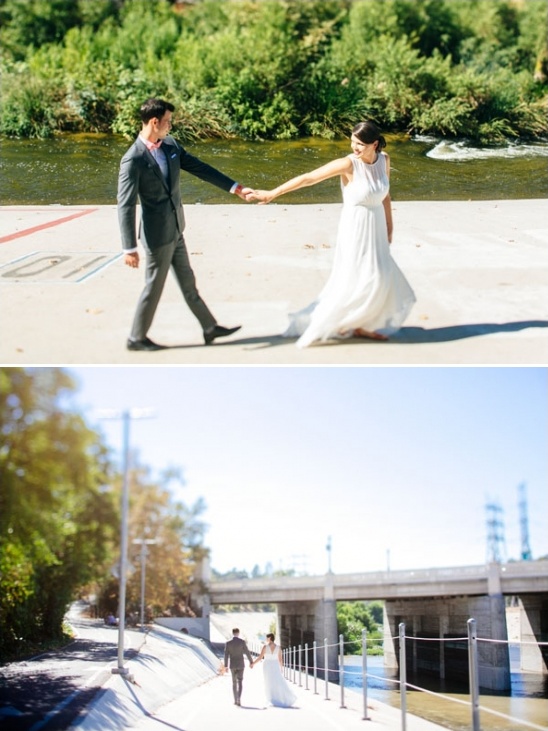 A newly married couple walks hand in hand on a sunny day