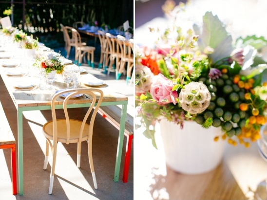 Outdoor dining table with floral arrangement and painted chairs