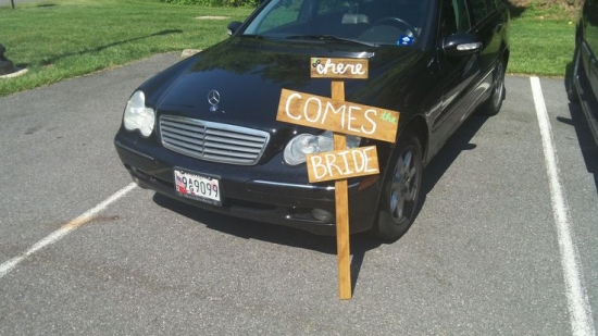 Black car with Here comes the bride sign, perfect for wedding day