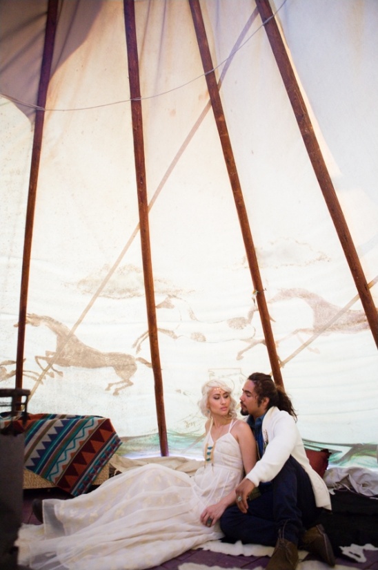 Boho wedding couple inside tipi tent with horse art