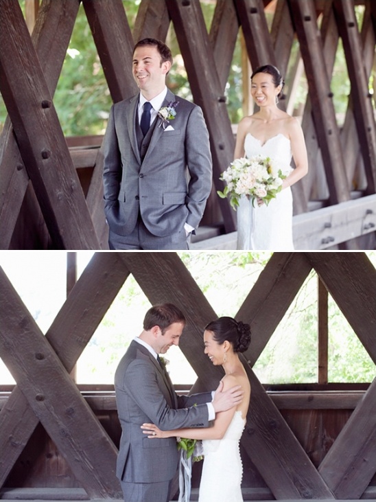 Wedding couple enjoying their special moment, standing on a wooden bridge