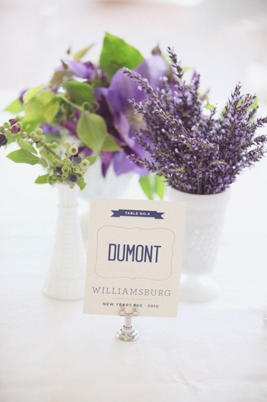Elegant table setting with purple flowers and a place card