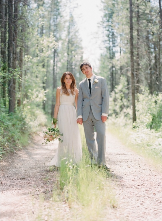Bride and groom on forest path wedding portrait