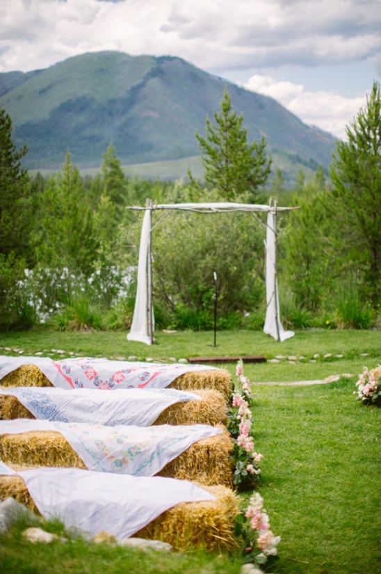 Rustic mountain wedding with hay bale seating outdoors