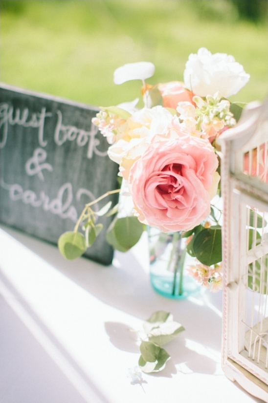 Wedding guest book table with floral centerpiece